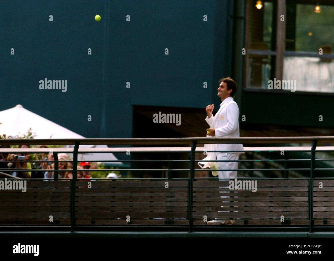 Roger Federer throws tennis balls to his fans below Stock Photo Alamy