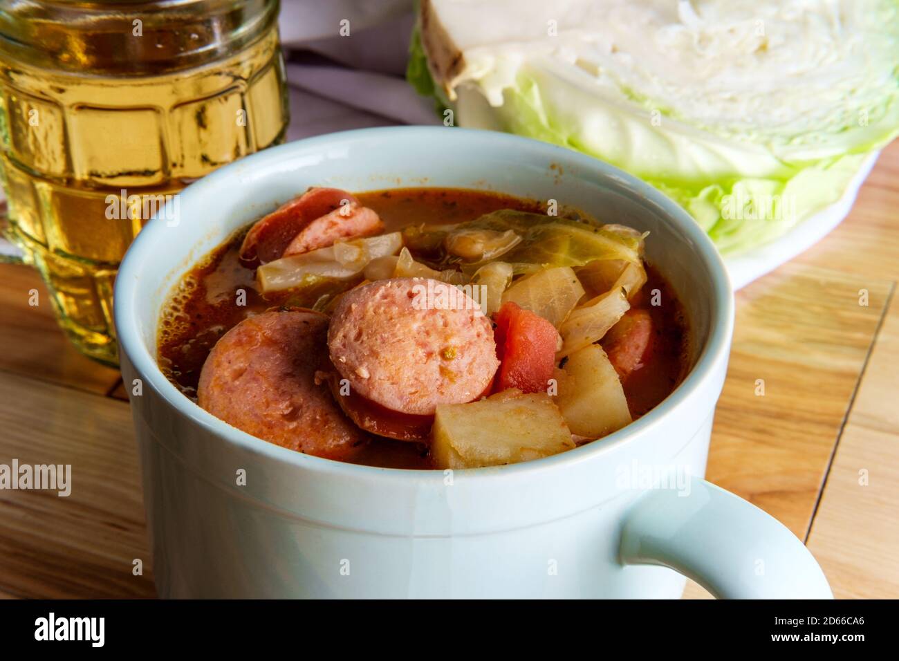German kielbasa Oktoberfest stew with cabbage potatoes and a beer stein