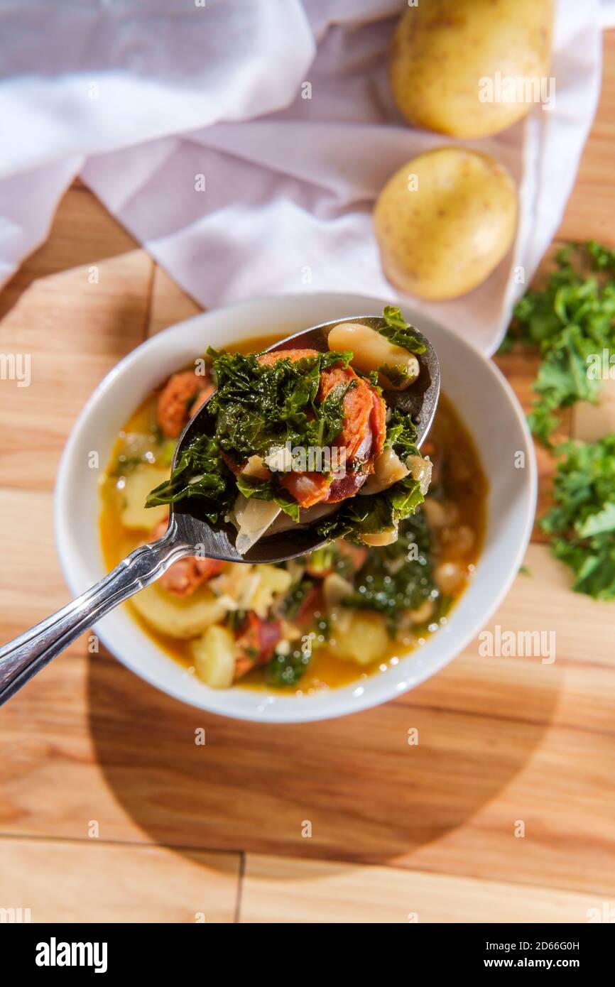 Traditional Portuguese caldo verde linguica sausage soup with kale and