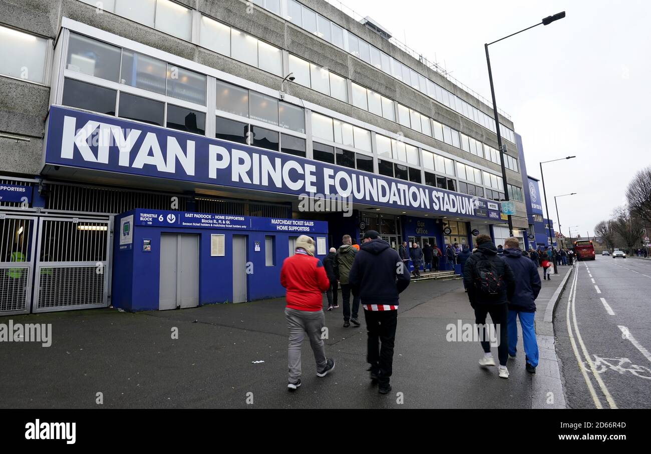 Fans walk past the entrance to the Kiyan Prince foundation stadium, home of Queens Park Rangers Stock Photo