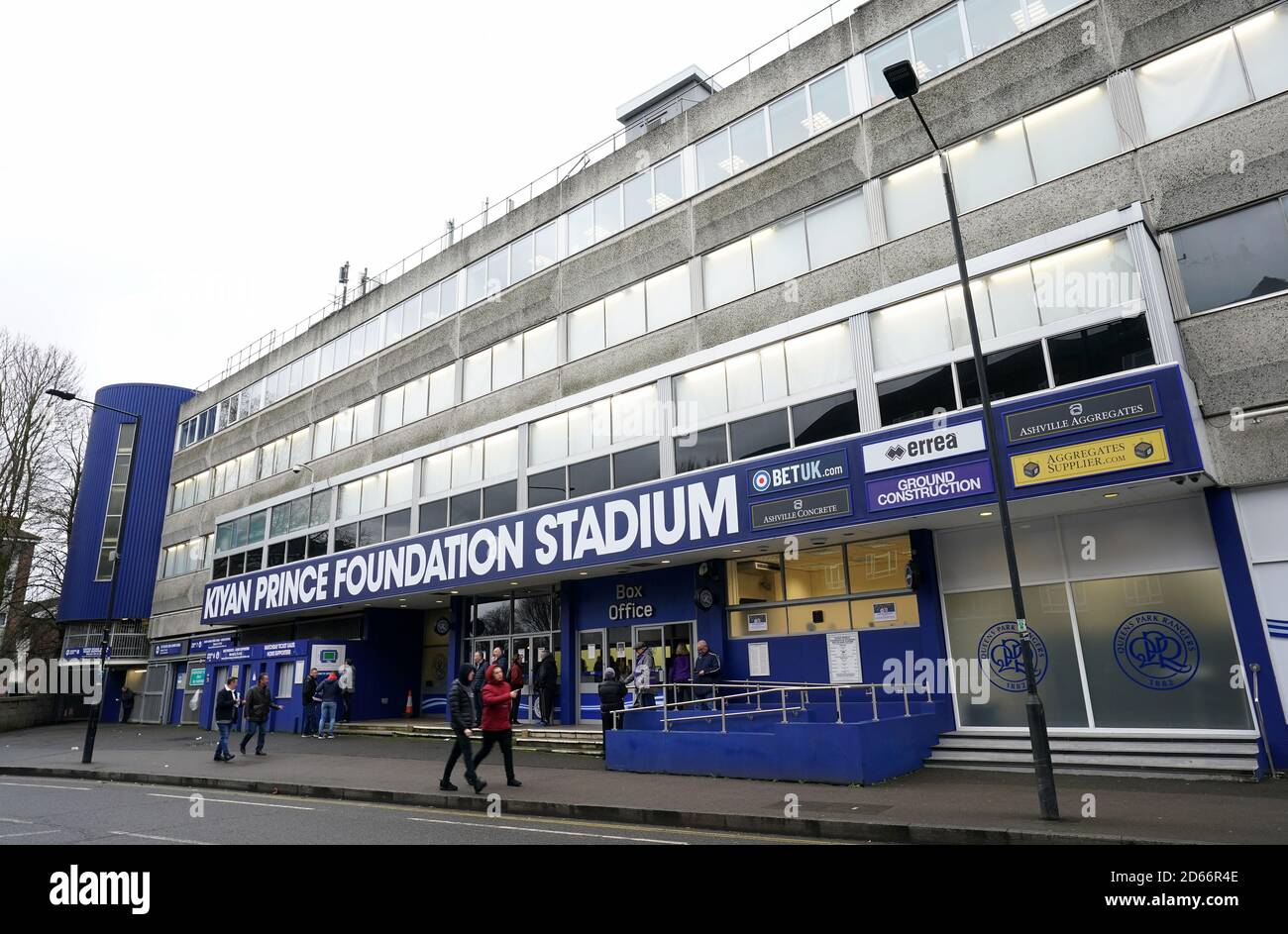 Fans walk past the entrance to the Kiyan Prince foundation stadium, home of Queens Park Rangers Stock Photo
