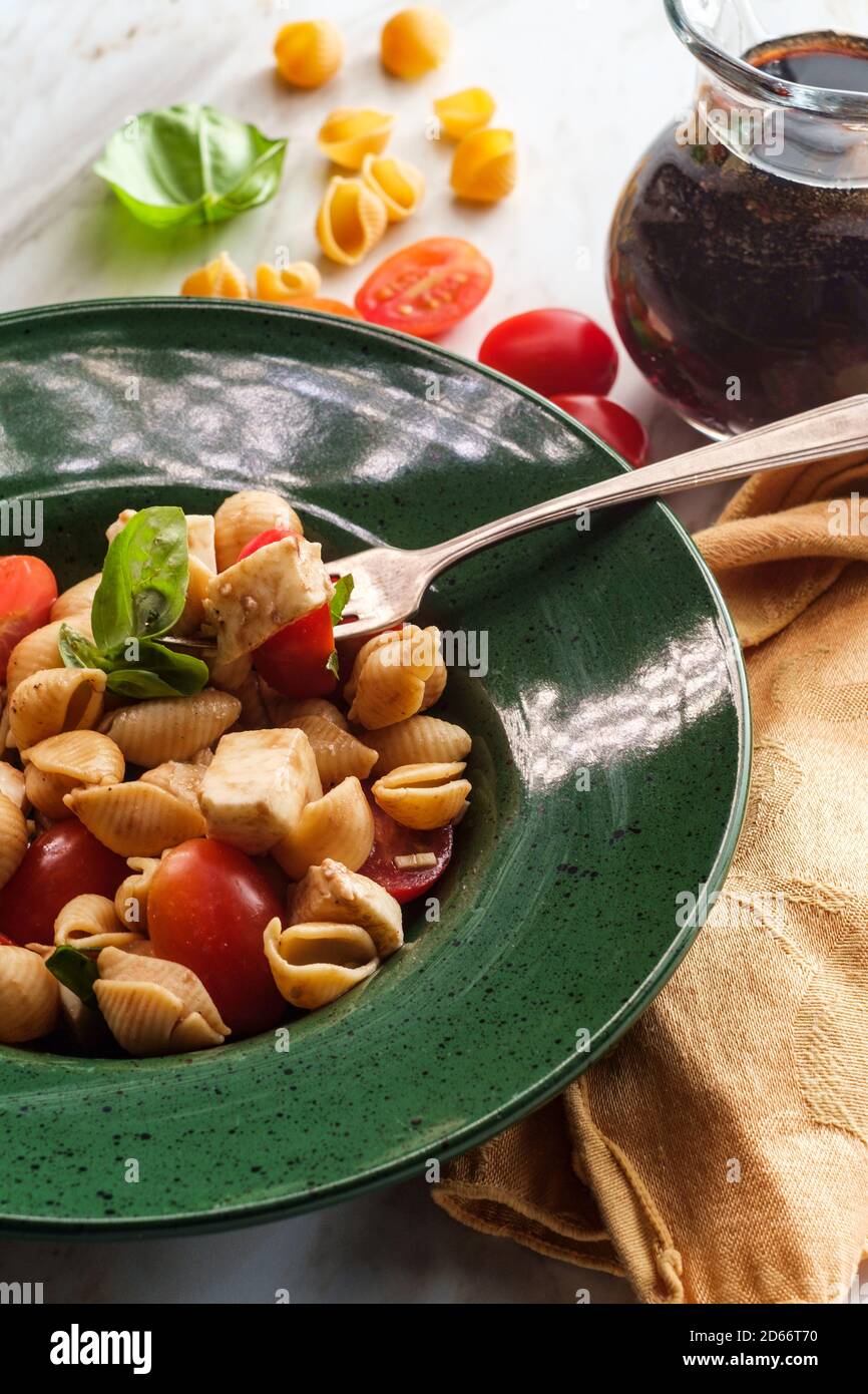 Fresh caprese pasta salad with extra virgin olive oil balsamic vinegar
