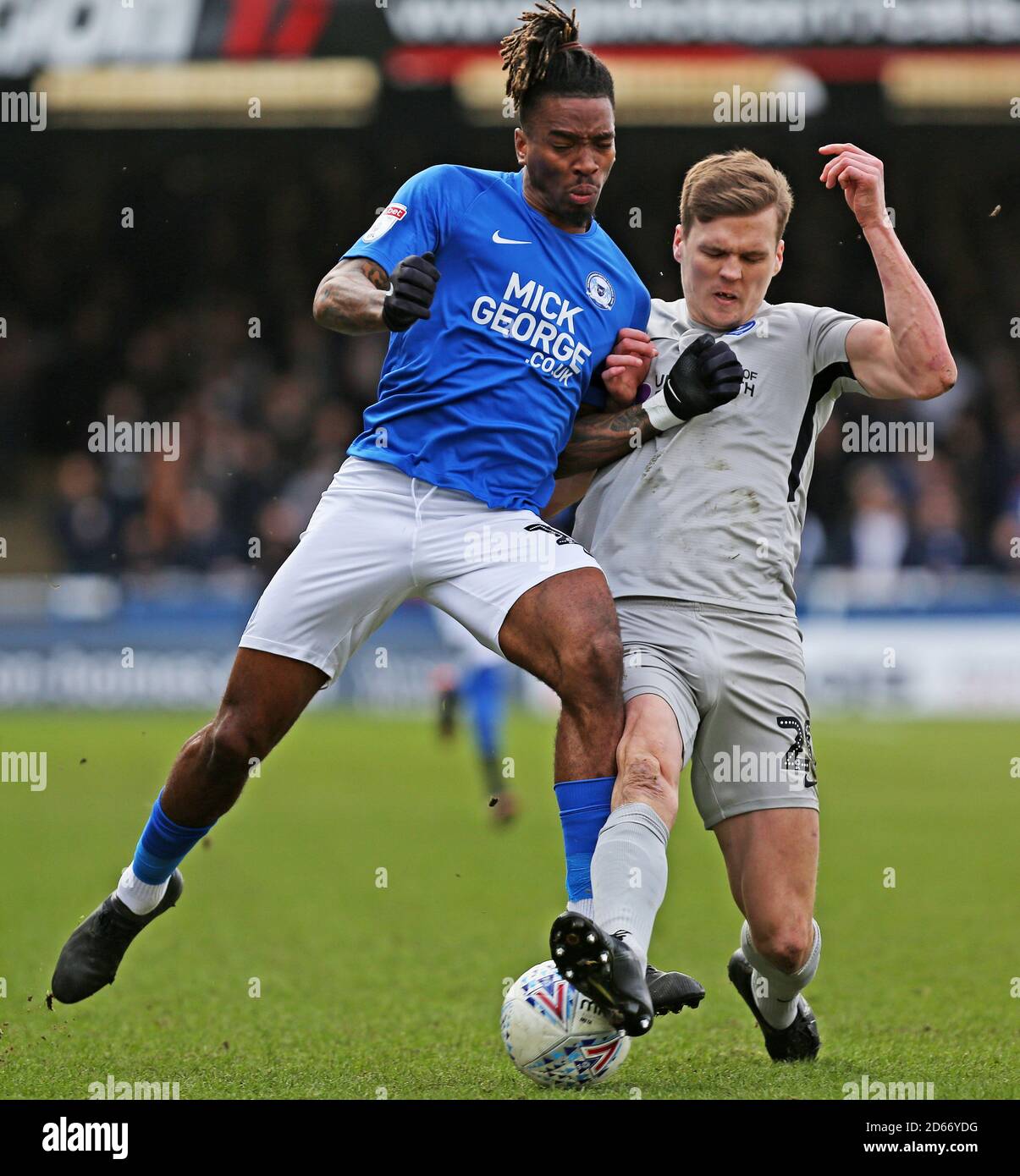 Peterborough United's Ivan Toney (left) and Portsmouth's Sean Raggett ...