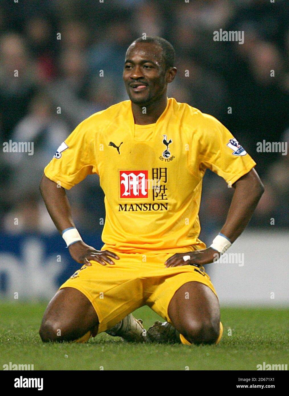 Tottenham Hotspur's Didier Zokora sits dejected after being dismissed by referee Steve Bennett Stock Photo
