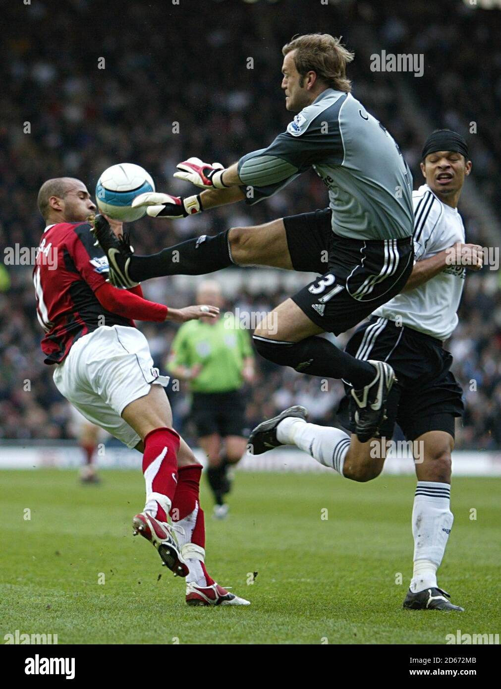 Derby County goalkeeper Roy Carroll rushes out to make the save to deny Fulham's Diomansy Kamara. Stock Photo