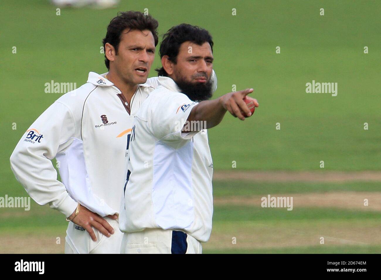 Surrey's captain Mark Ramprakash (l) and spin bowler Saqlain Mushtaq try to organise the field together Stock Photo