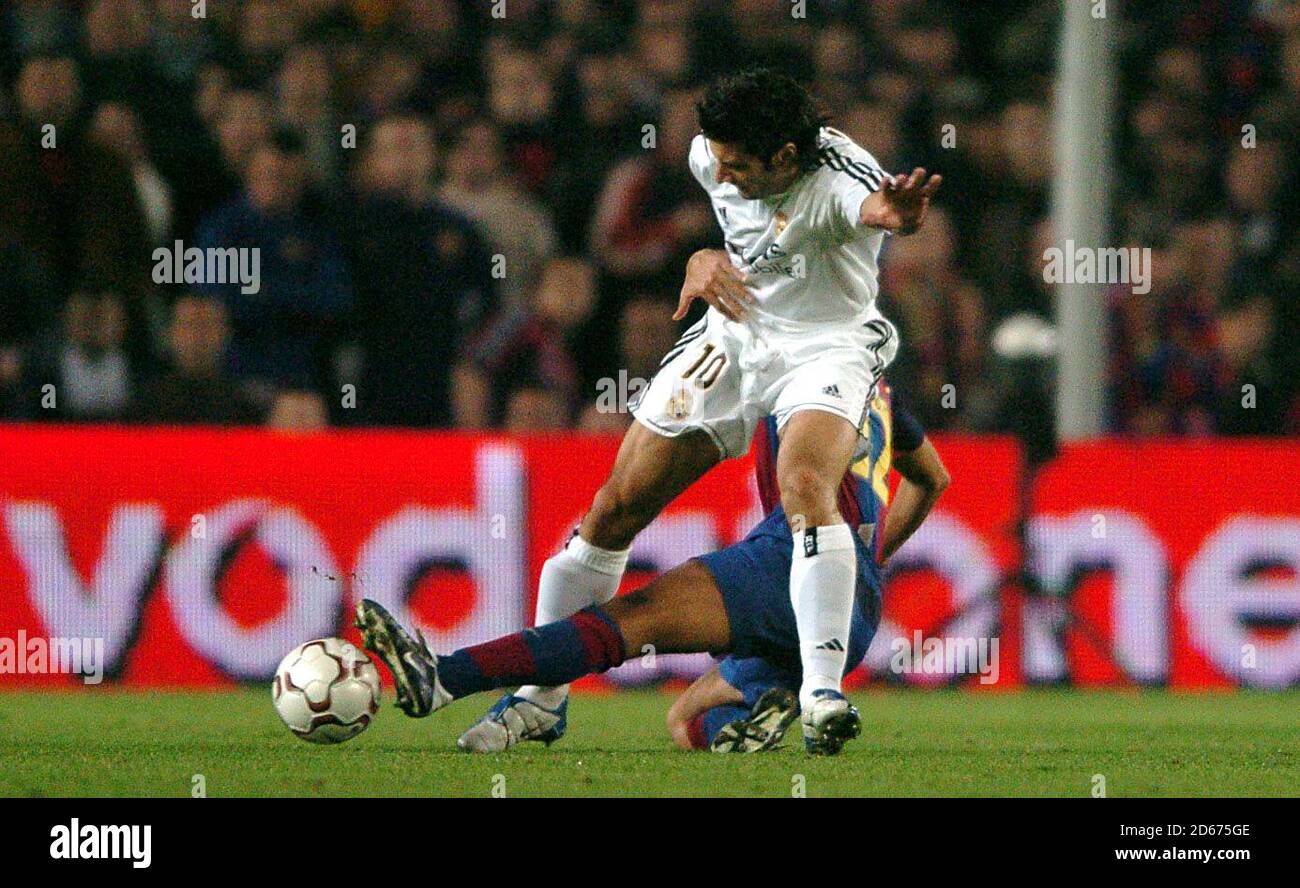 l-r; Real Madrid's Luis Figo is tackled through the legs by Barcelona's Giovanni Van Bronckhorst Stock Photo