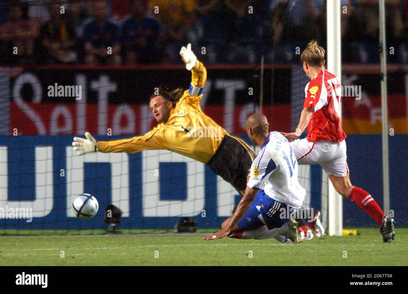 France's Thierry Henry shoots past Switzerland's goalkeeper Jorg Stiel to score his sides second goal Stock Photo
