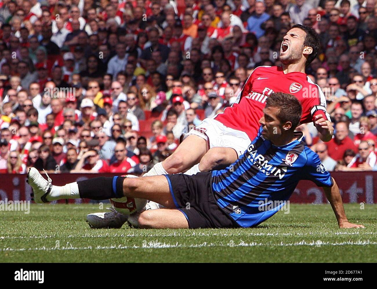 Middlesbrough's Gary O'Neil challenges Arsenal's Francesc Fabregas. Stock Photo
