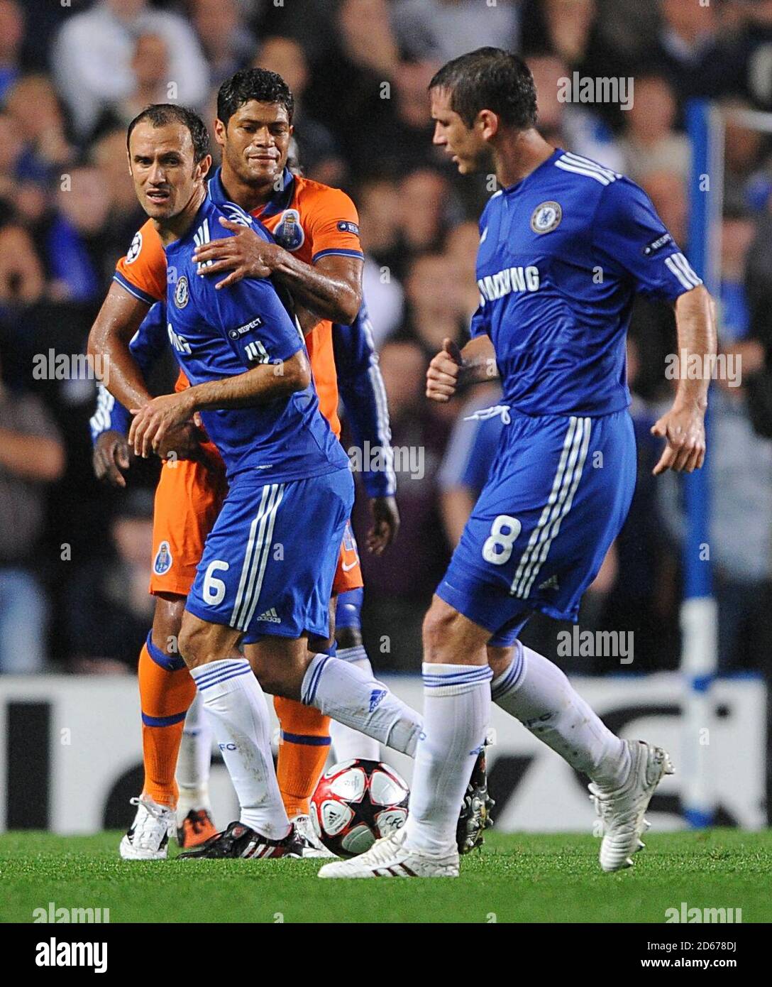 Chelsea's Frank Lampard (right) passes the ball to team mate Ricardo Carvalho (left), who is held back by FC Porto's Givaldinho Hulk. Stock Photo