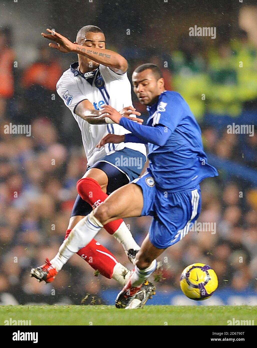 Portsmouth's Kevin-Prince Boateng (left) and Chelsea's Ashley Cole battle for the ball Stock Photo