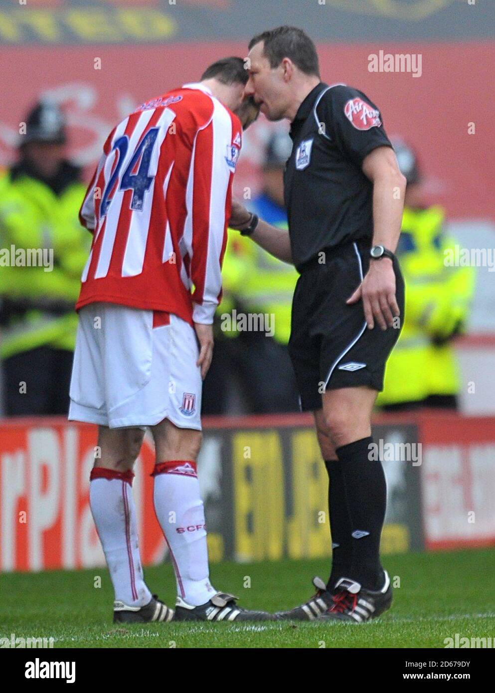 Referee Kevin Friend (right) has a word with Stoke City's Rory Delap (left). Stock Photo