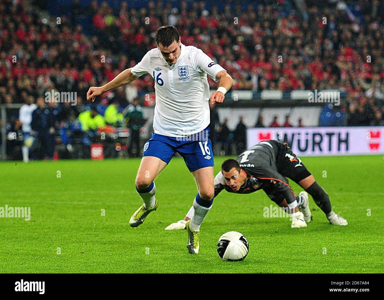 England's Adam Johnson skips past Switzerland goalkeeper Diego Benaglio to score his side's second goal of the game Stock Photo
