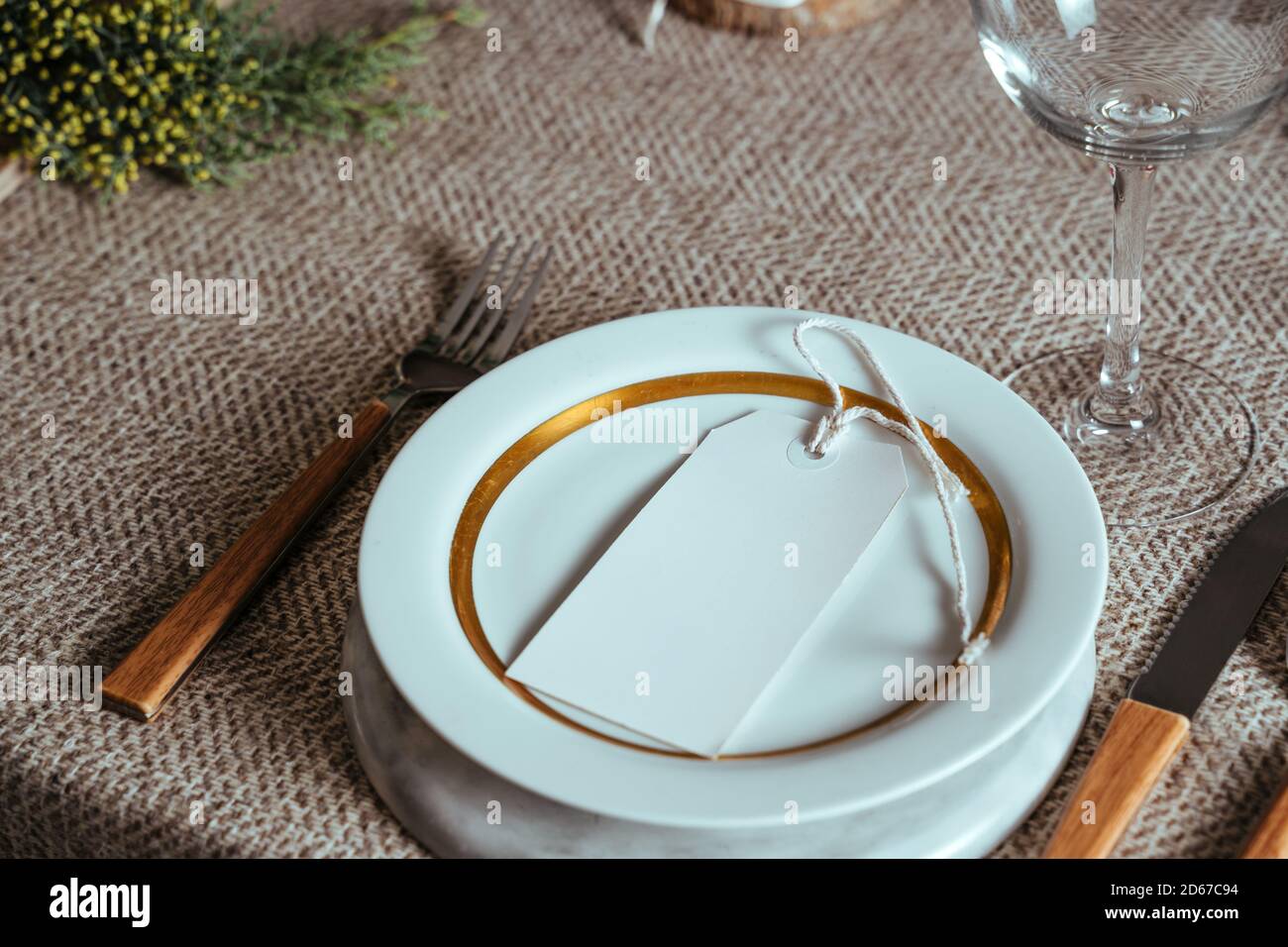 https://c8.alamy.com/comp/2D67C94/holiday-gold-place-setting-christmas-table-menu-with-empty-card-ornaments-and-natural-pine-branch-on-rustic-beige-mantel-dinner-at-home-2D67C94.jpg