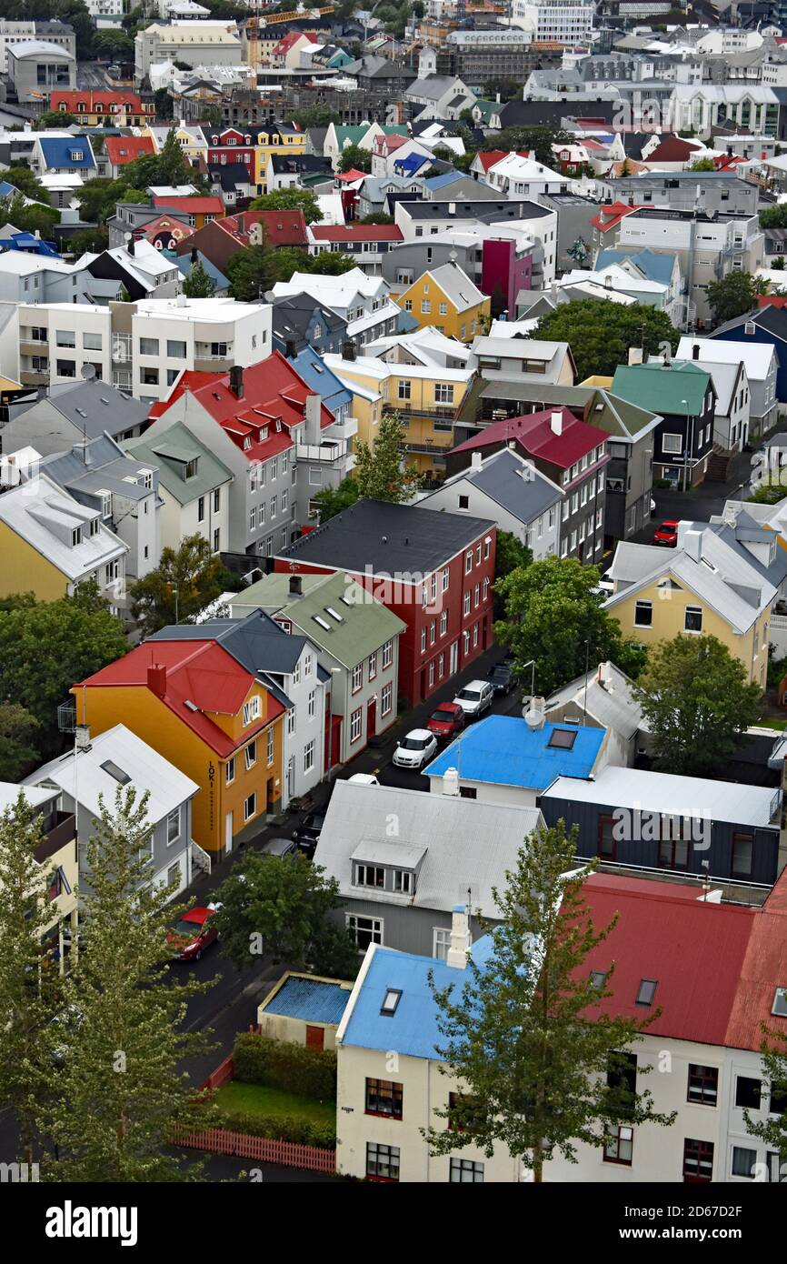 A view from the top of Hallgrimskirkja Church tower. Rows of brightly coloured, modern Scandinavian houses can be seen across Reykjavik city, Iceland. Stock Photo