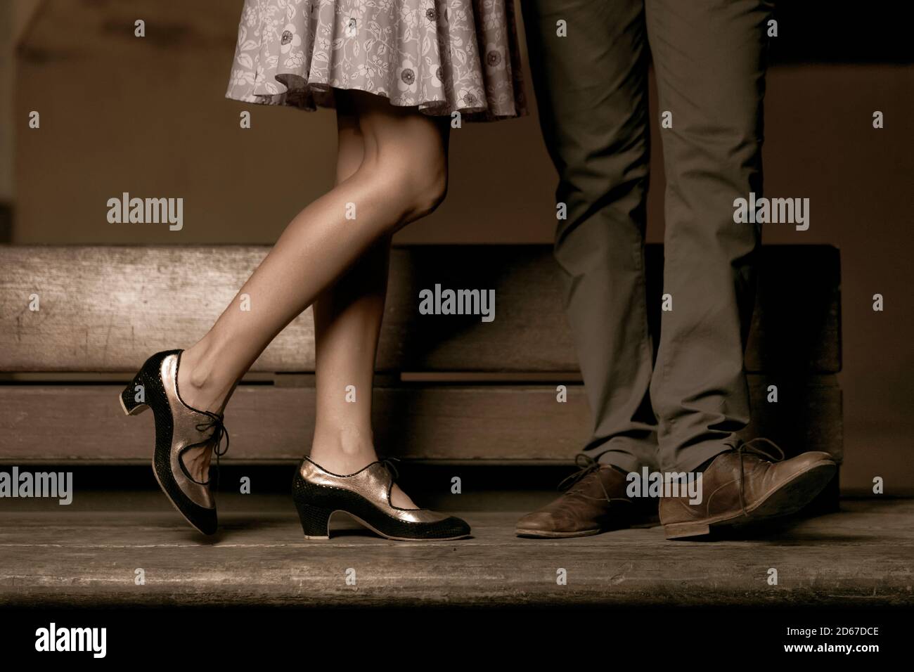 Legs of a couple standing while her is kissing him. Stock Photo