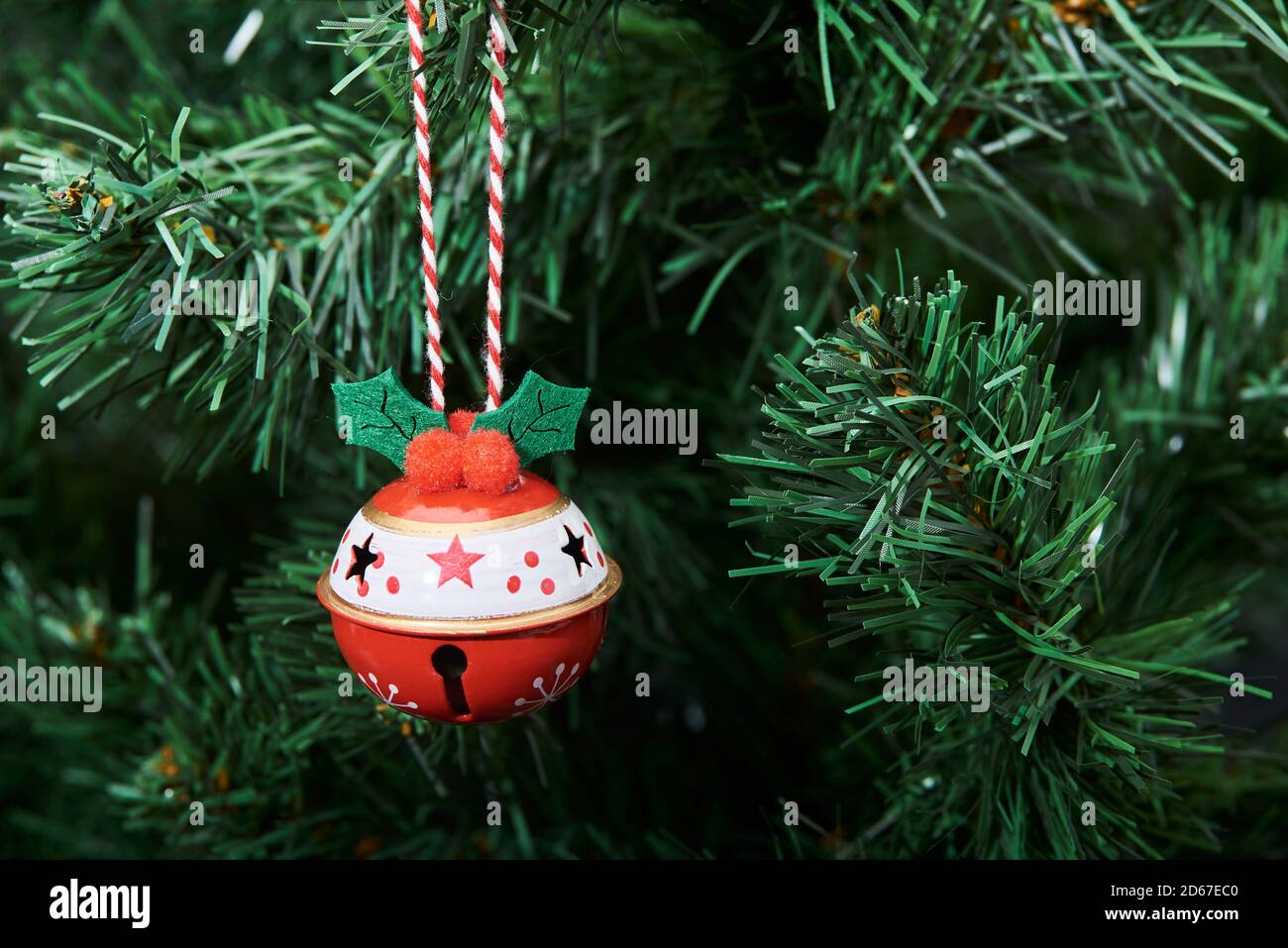 Red and white beautiful decorated bauble hanging from a Christmas tree, copy space Stock Photo