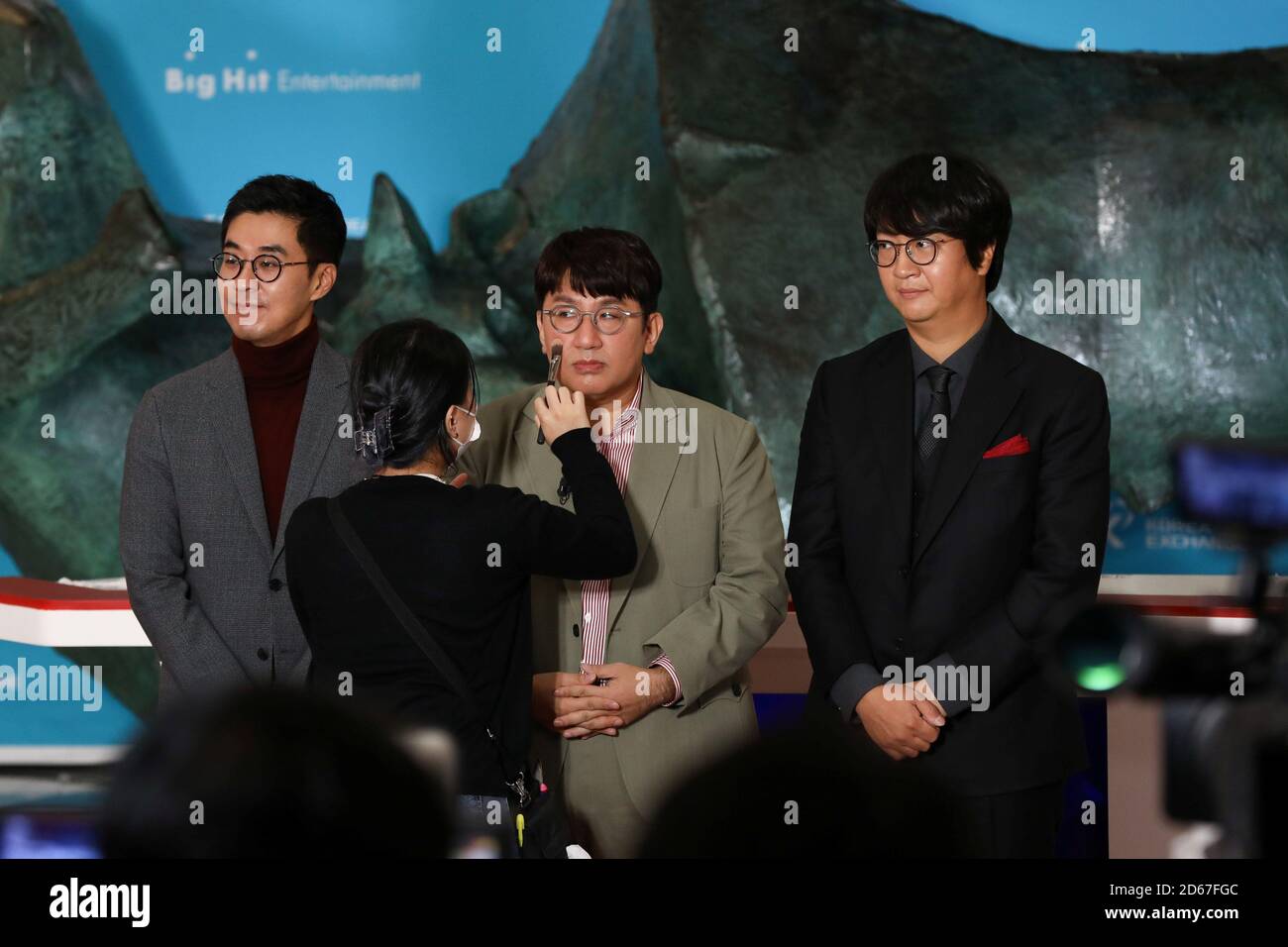 Bang Si-hyuk, founder of Big Hit Entertainment Co., center, gets make-up  during the company's initial public offering ceremony at the Korea Exchange  in Seoul, South Korea, on Thursday, Oct. 15, 2020. SeongJoon