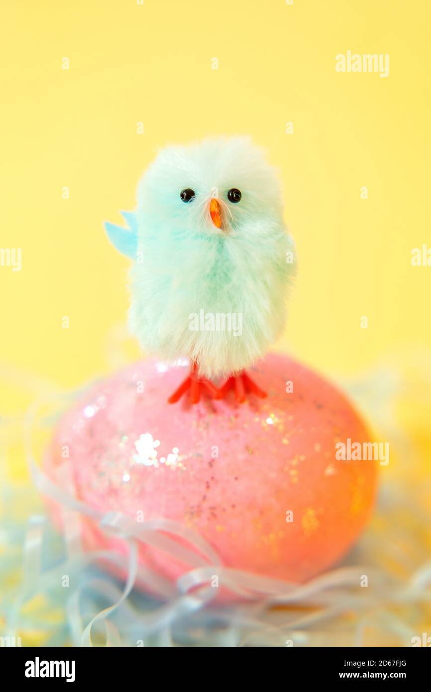 Blue chick standing on Easter egg Stock Photo