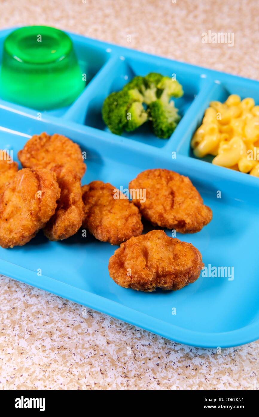 Grade school lunch tray of chicken nuggets with broccoli macncheese