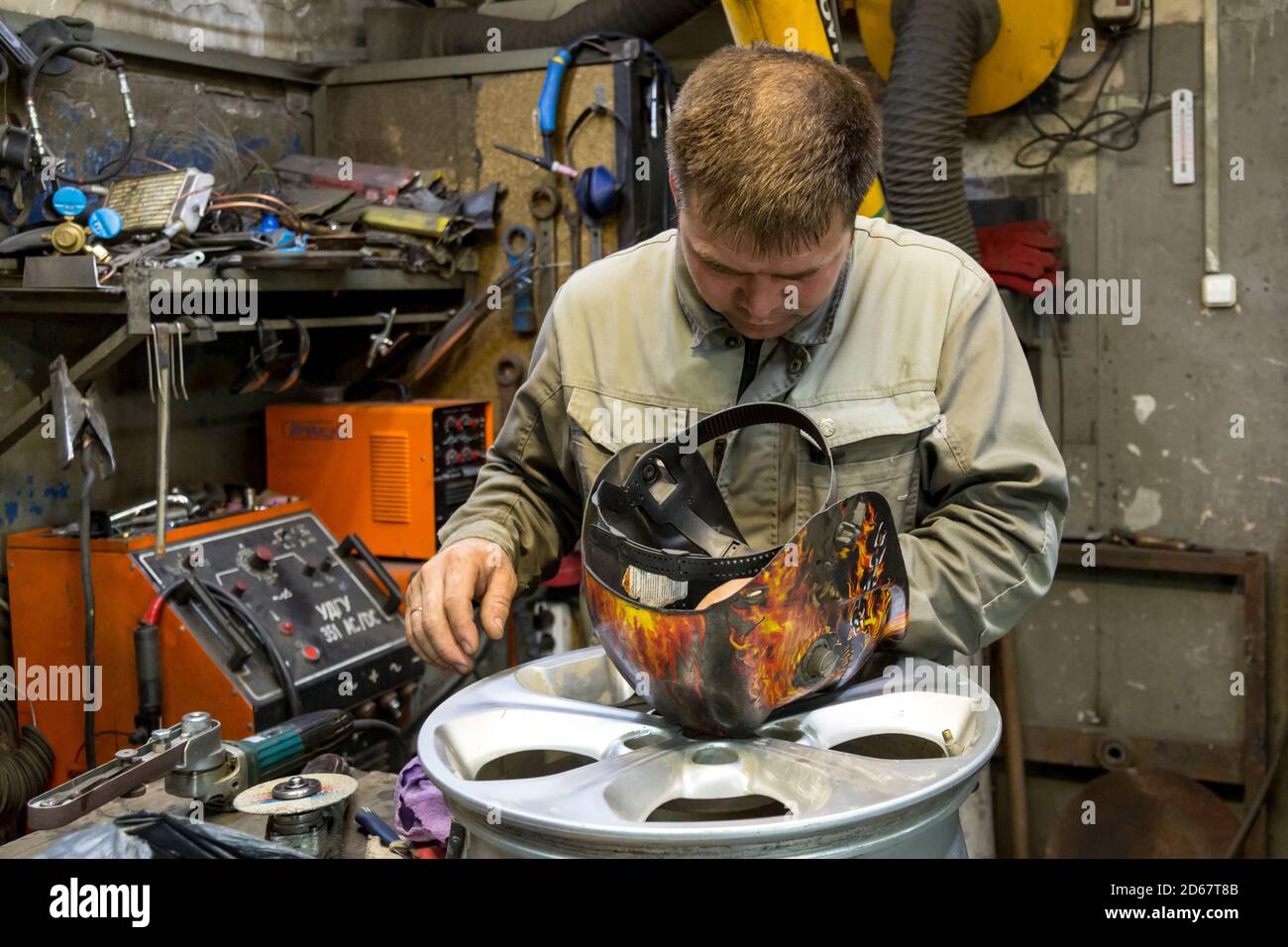 Welding a wheel rim from an aluminum car Stock Photo Alamy