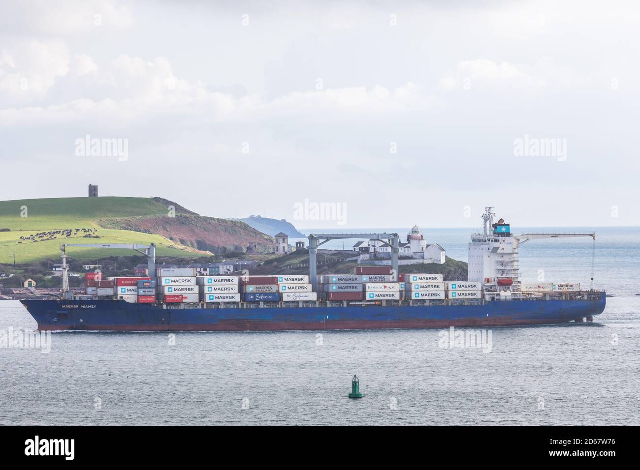 Roches Point, Cork, Ireland. 14th October, 2020. Container ship Maersk Niamey passes Roches Point as she arrives in Cork Harbour to collect containers for export to Tilbury, UK. With ongoing Brexit  talks between the EU and UK over a free trade agreement there is uncertainty among exporters to the effects of a no-deal scenario will have on their business.  - Credit David Creedon / Alamy Live News Stock Photo