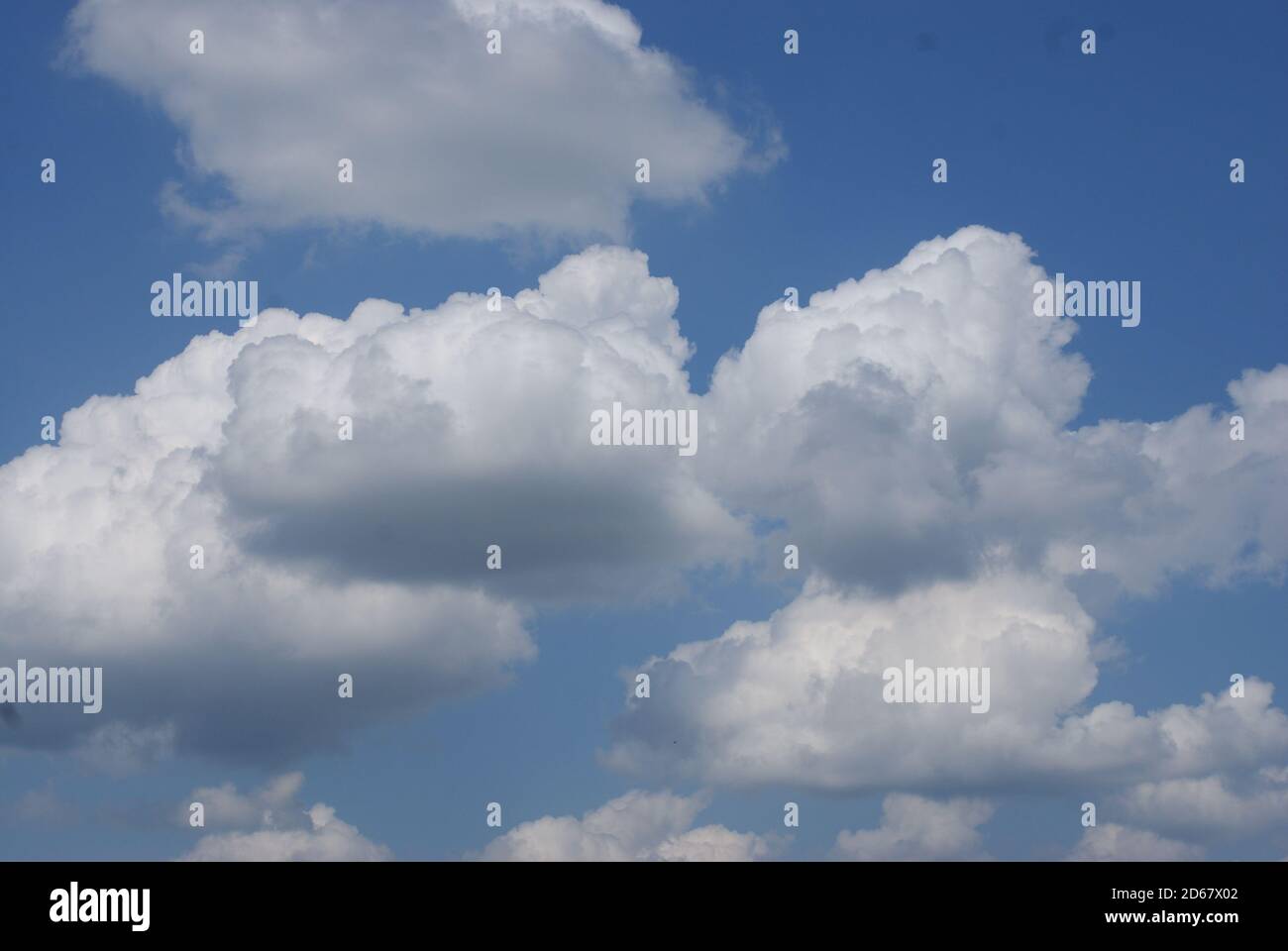 Bright blue sky with fluffy white clouds-perfect for wallpapers Stock ...