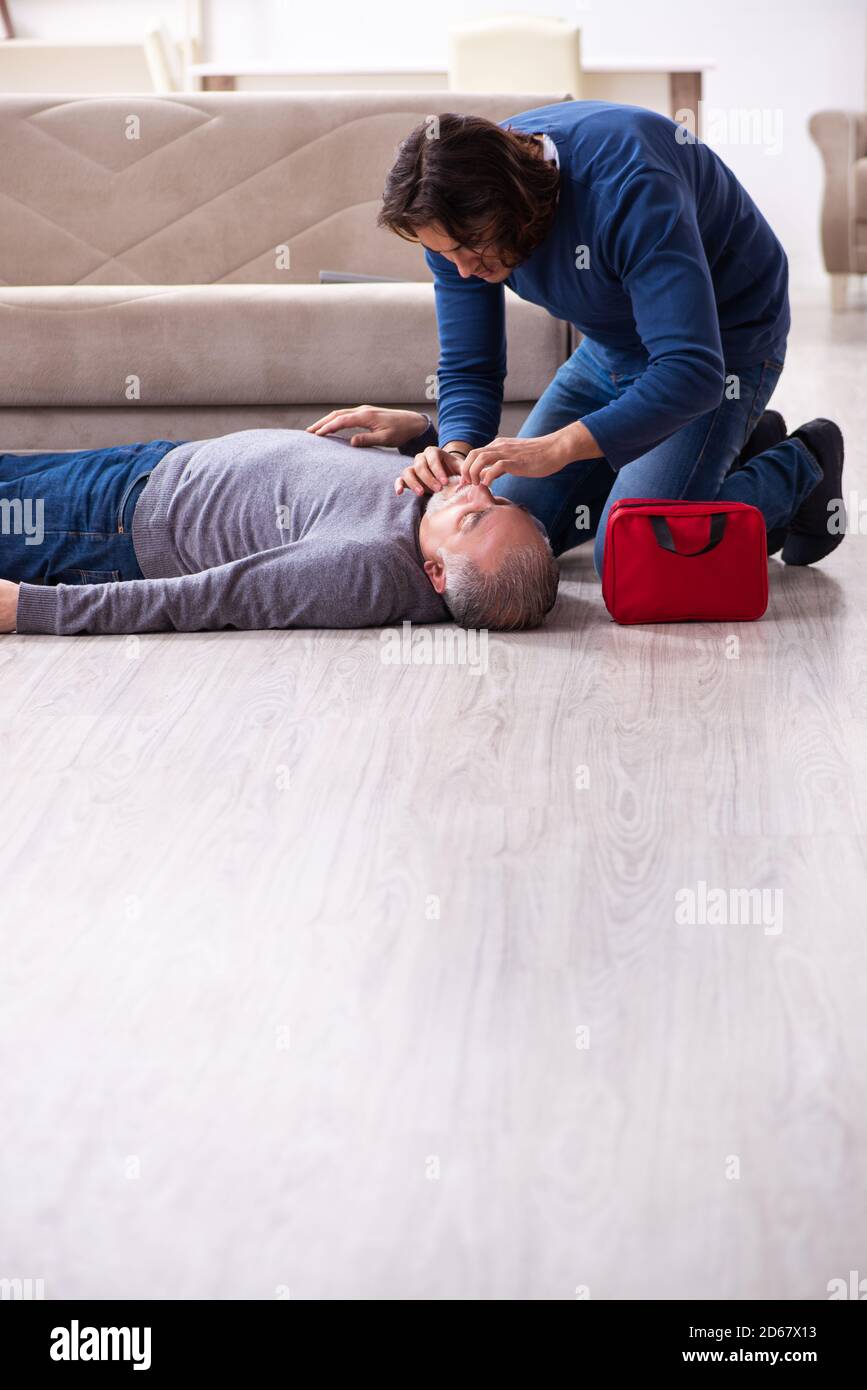 Grandfather and grandson in the first aid concept Stock Photo