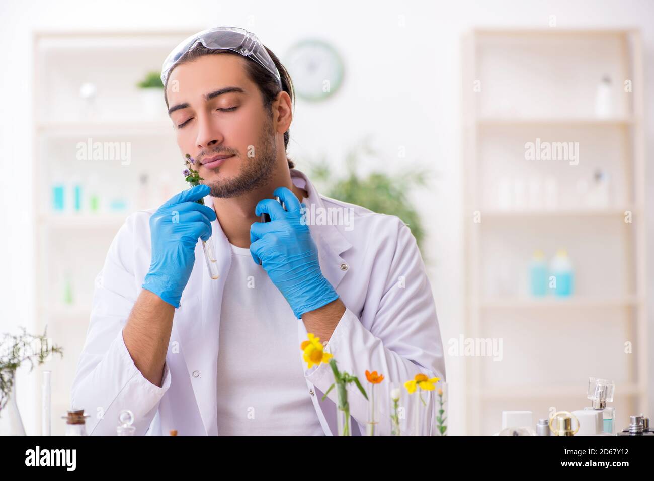 Young chemist in perfume synthesis concept Stock Photo Alamy