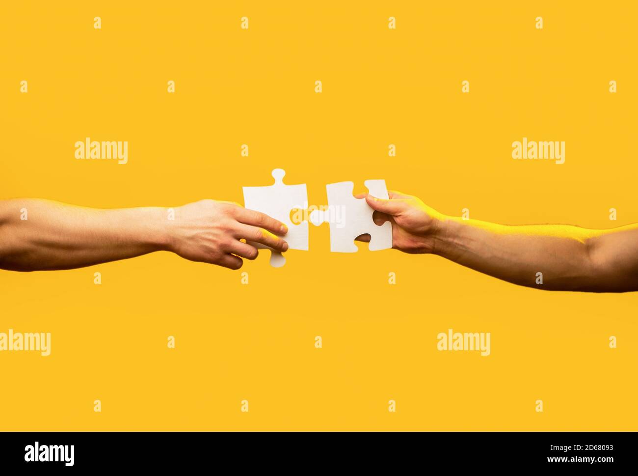 Man hands connecting couple puzzle piece. Business solutions, target, success, goals and strategy concepts. Hand connecting jigsaw puzzle. Business Stock Photo