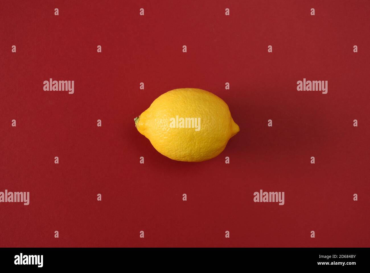 Whole lemon isolated on a red background Stock Photo