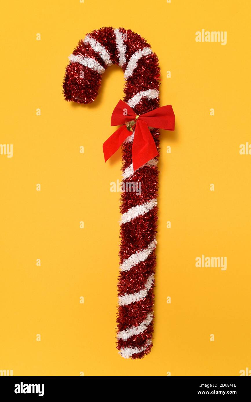 Tinsel Candy Cane on yellow Stock Photo