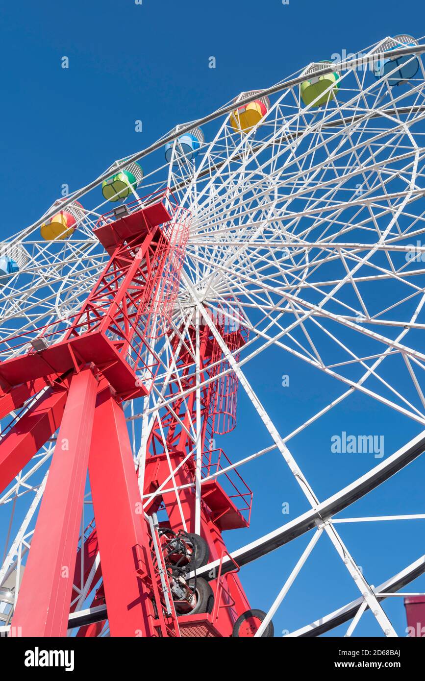 Luna Park, Sydney, Oct 2020: Normally full of people on a sunny weekend day, the ferris wheel at Sydney's Luna Park stops for cleaning between rides Stock Photo