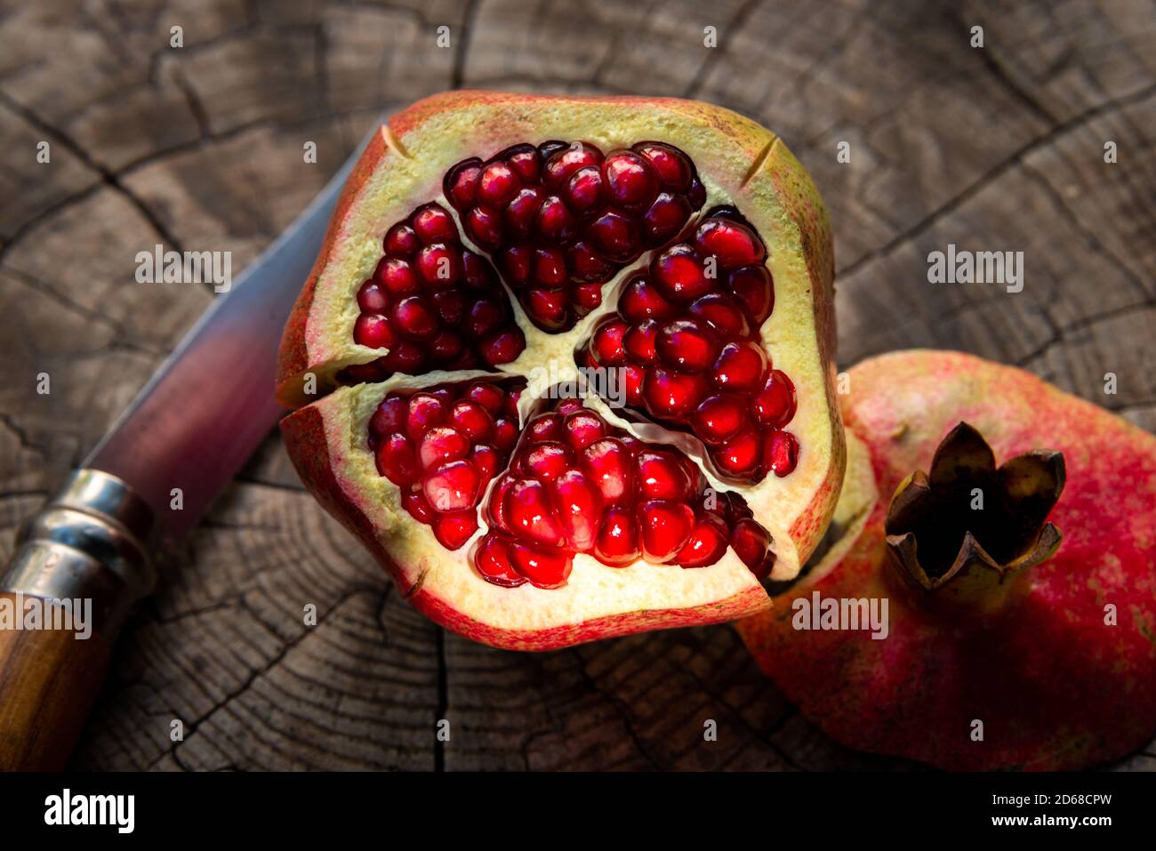 Can opener and pomegranate - open pomegranate for juice Stock Photo