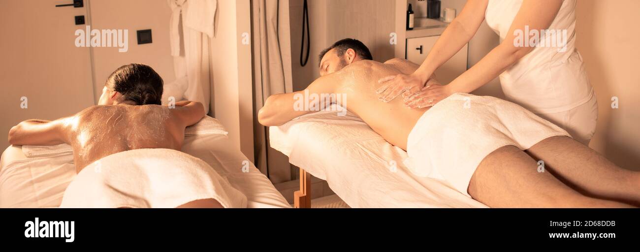 Exfoliate older skin with a body scrub. time for pampering body and skin at spa. Couple getting peel procedure after body massage. Stock Photo