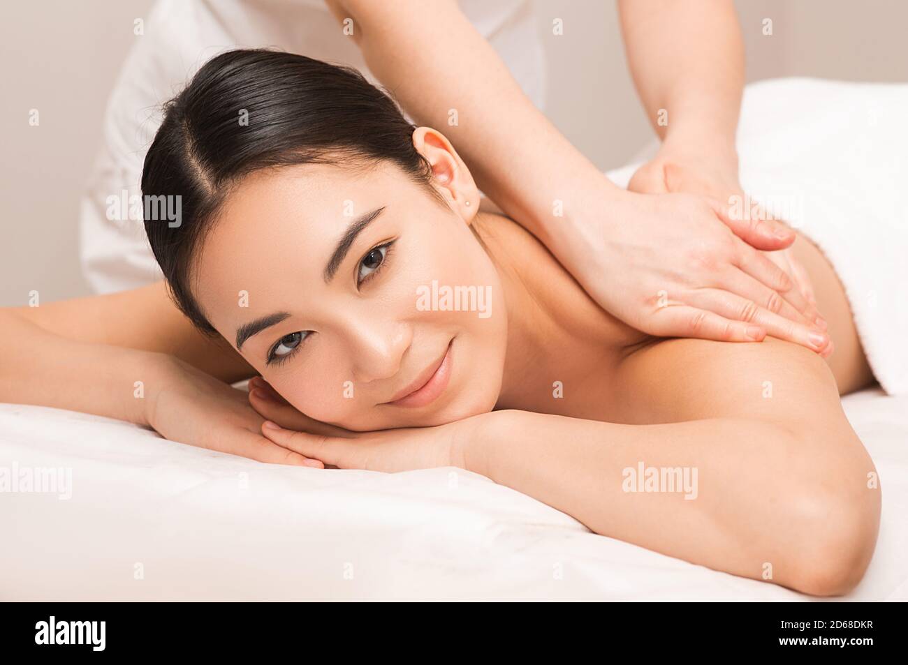 Thai massage therapy. Portrait asian woman enjoying massage at the spa. Stock Photo