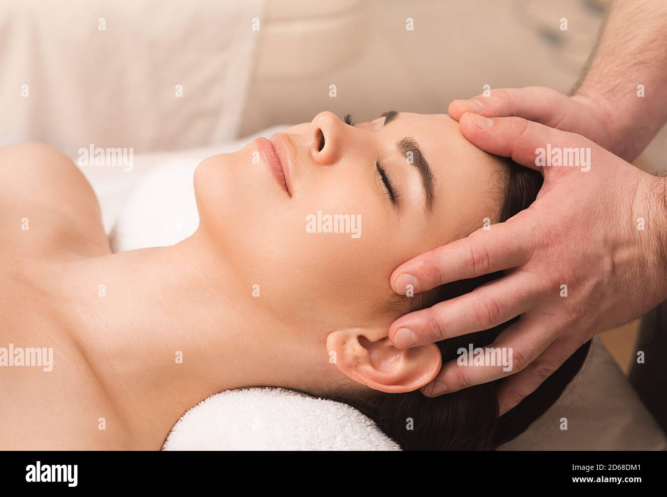 Head massage antistress. Relieve fatigue and relieve headaches using oriental massage. Woman at spa Stock Photo