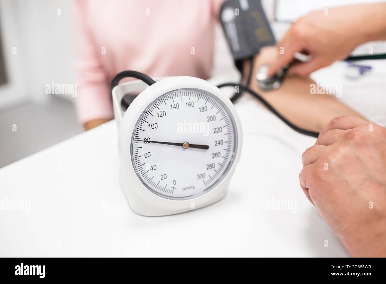 doctor measuring arterial blood pressure of a patient, close-up Stock Photo