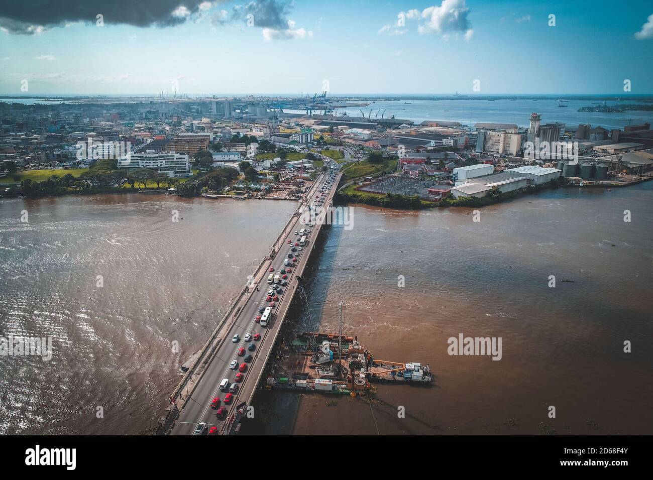 Cote d'Ivoire (Ivory Coast), Abidjan: aerial view of the business district of Le Plateau with the port and the Felix Houphouet-Boigny Bridge under ren Stock Photo