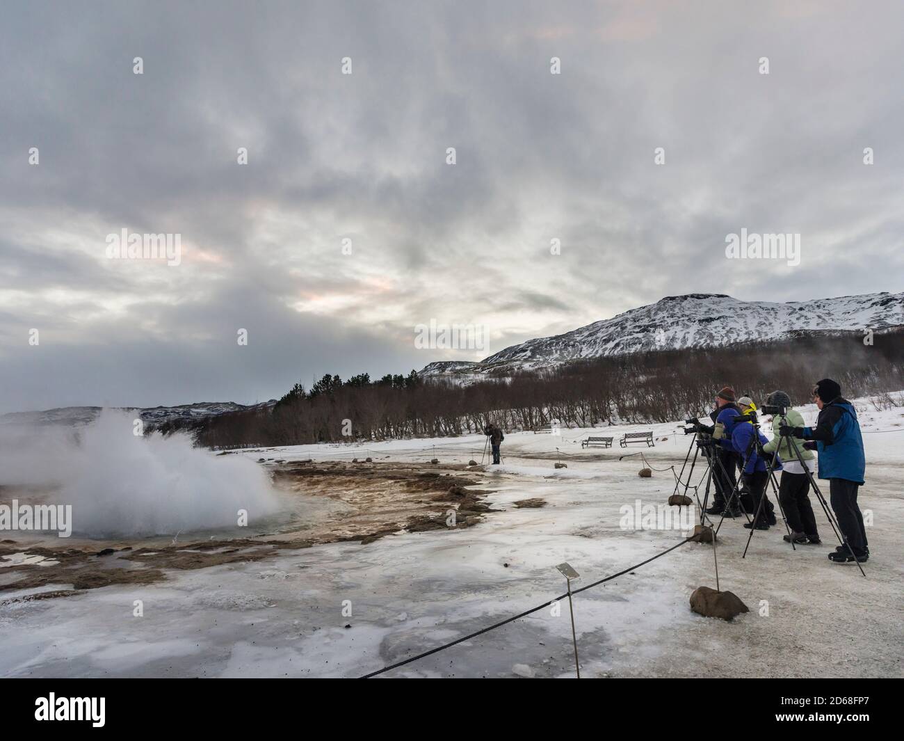 Photographers watching the geysir Strokkur. The geothermal area Haukadalur part of the touristic route Golden Circle during winter.   europe, northern Stock Photo