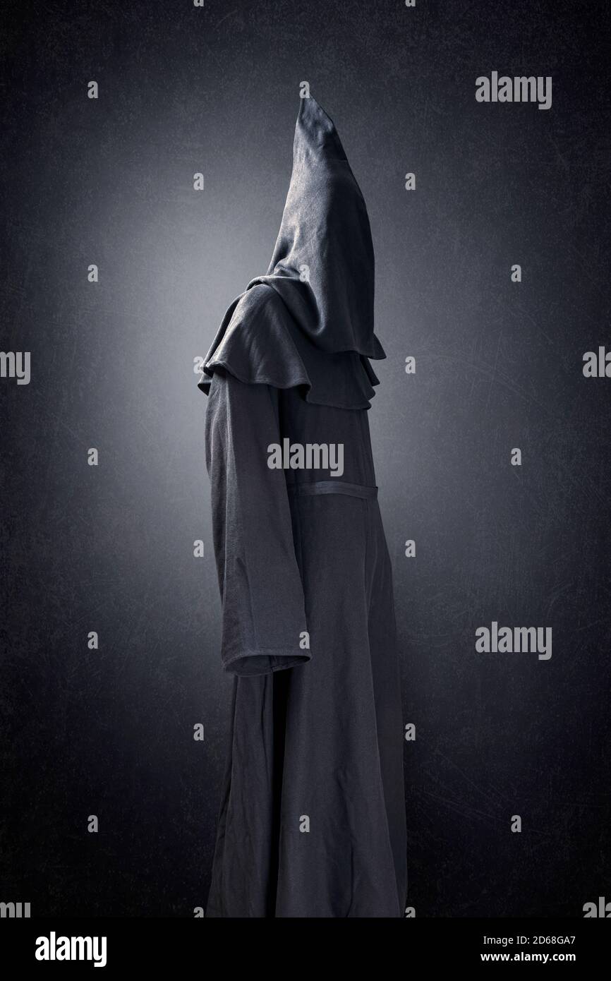 Scary figure in hooded cloak Stock Photo - Alamy