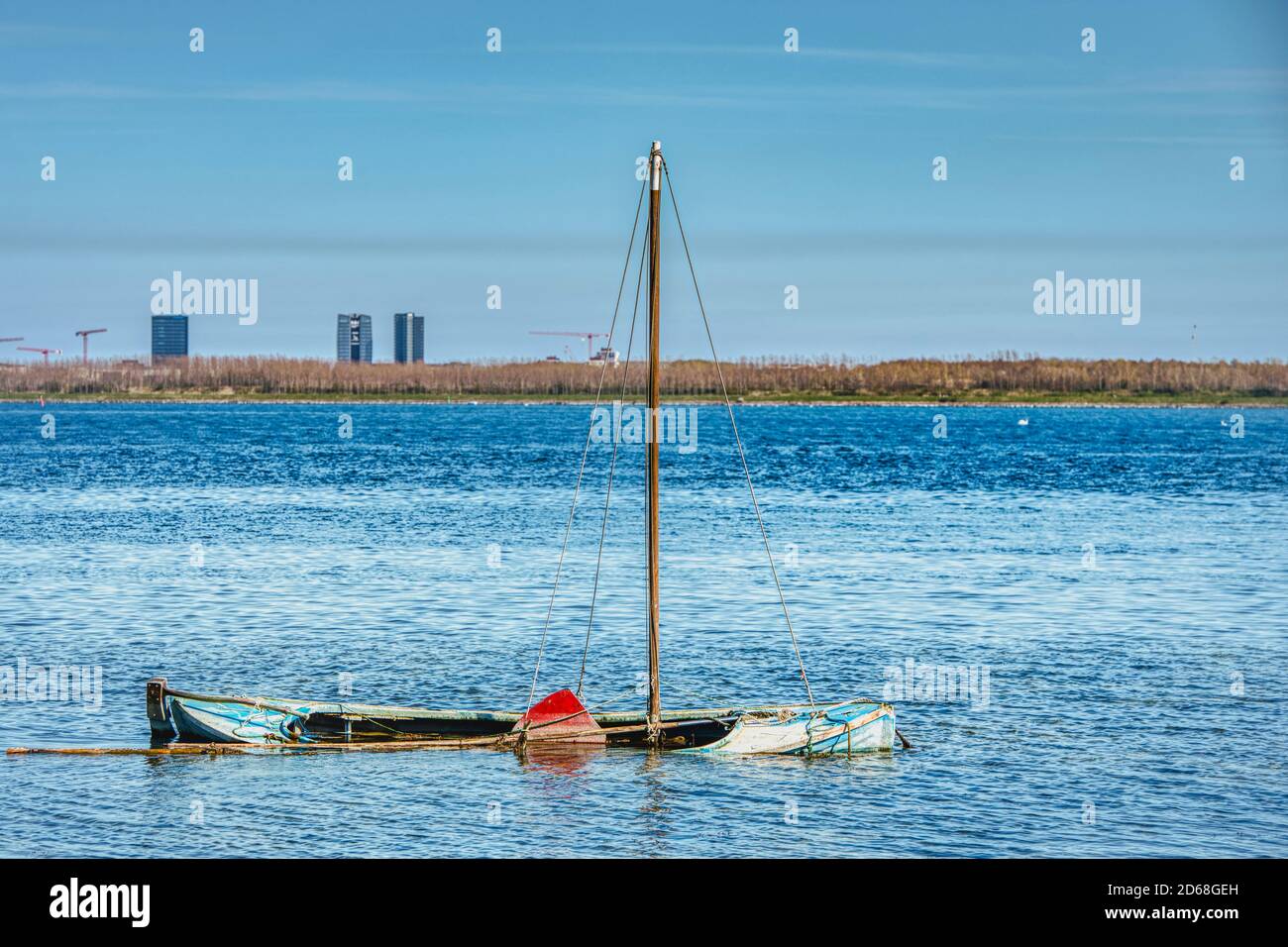 An abandoned sailing boat sunken in shallow water in a calm Baltic Sea bears resistance and decay concepts. Nature claims back what once was hers Stock Photo
