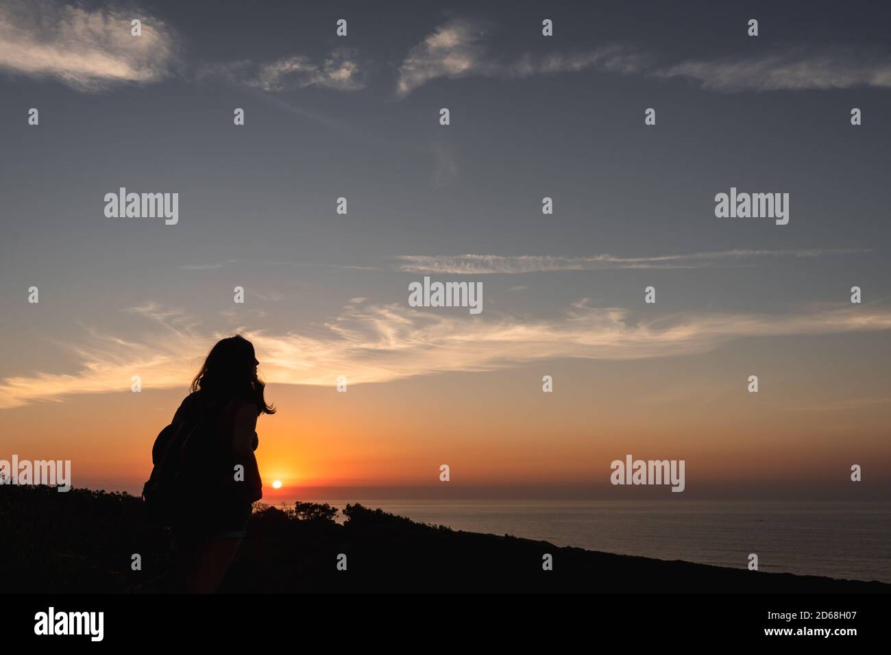Silhouette of a woman on a sunset background Stock Photo - Alamy