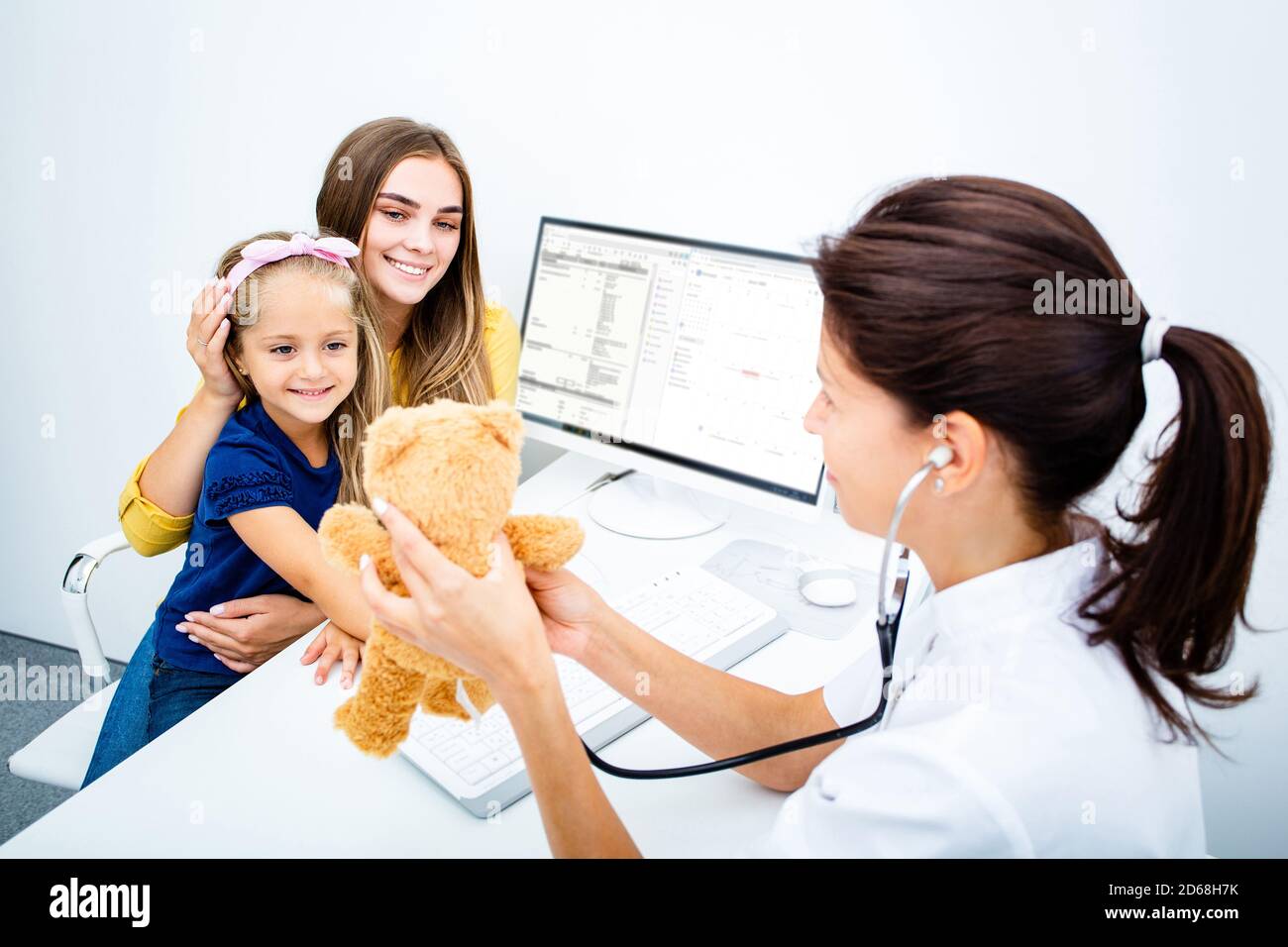 Parent with the child while medical exam at the hospital. Pediatrician