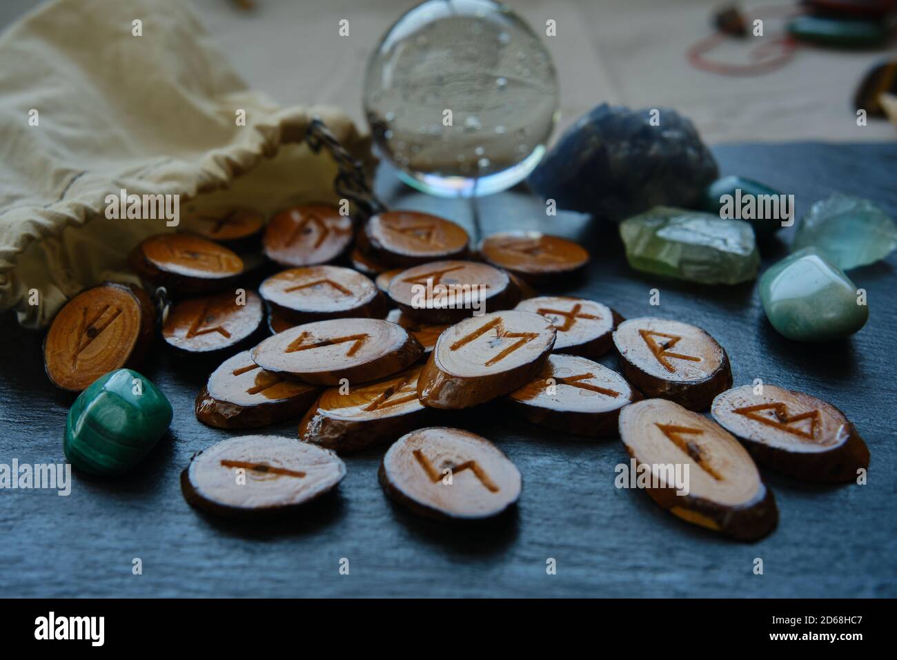 handmade wooden runes scattered on a black stone background Stock Photo ...