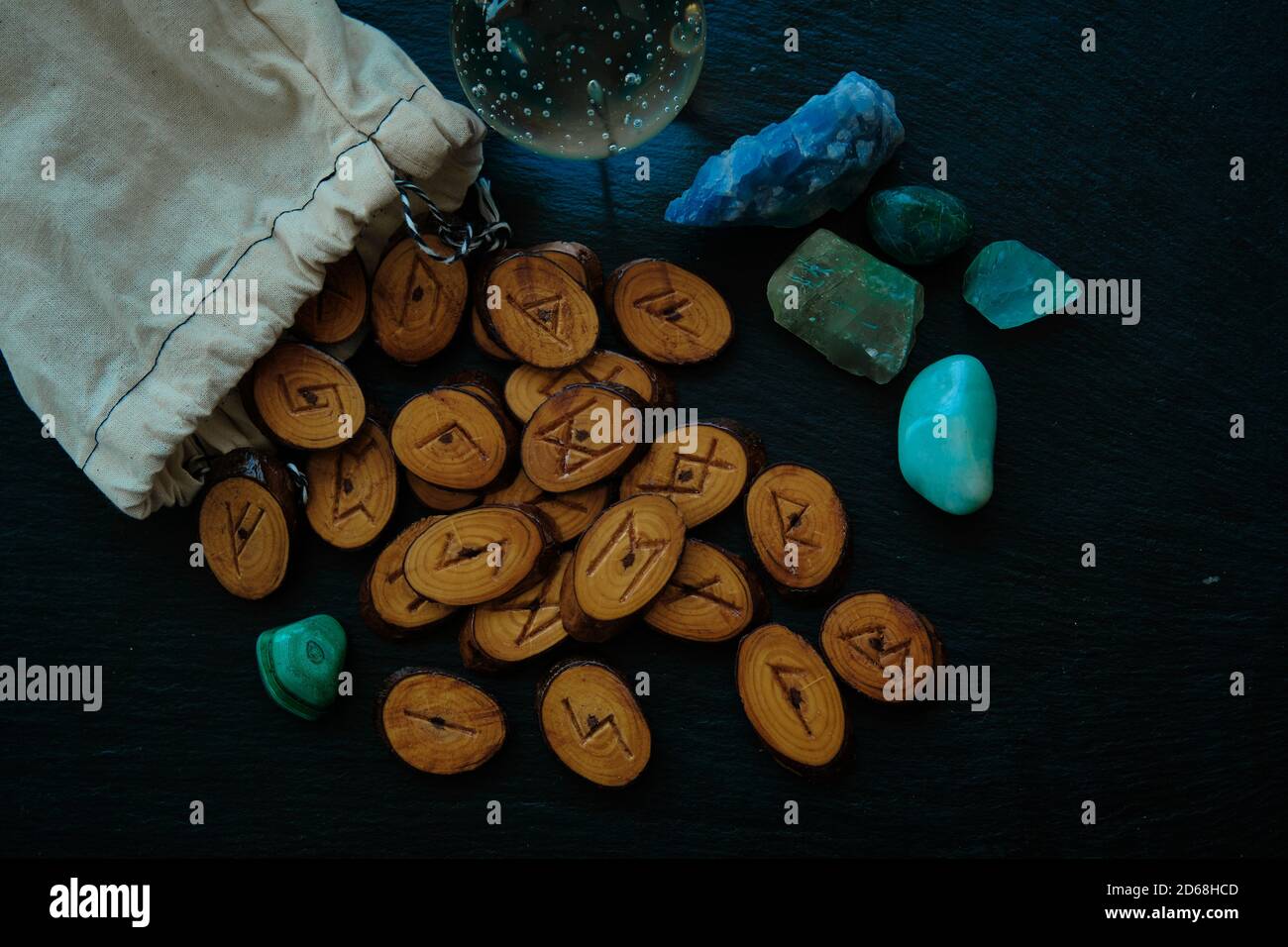 handmade wooden runes scattered on a black stone background Stock Photo ...