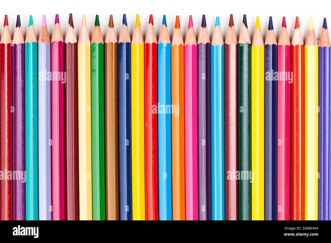 color pencils laid out in a row on a white background Stock Photo - Alamy