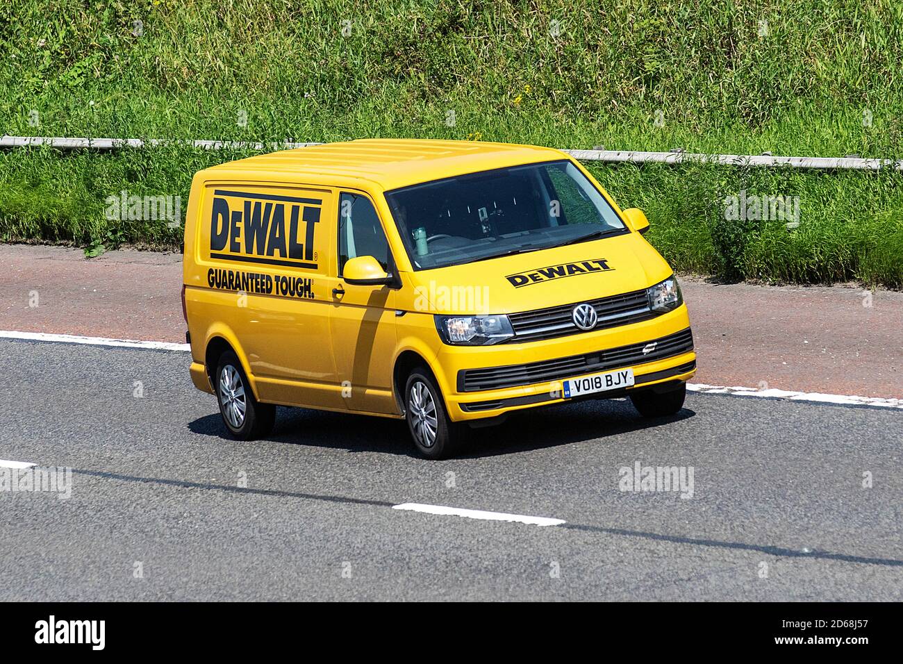 2018 yellow VW Volkswagen Transporter T32 T-Ln TDI DeWALT 'Guaranteed business logo on cammercial Vehicular traffic, moving vehicles, cars, vehicle driving on UK roads, motors, the M6 motorway