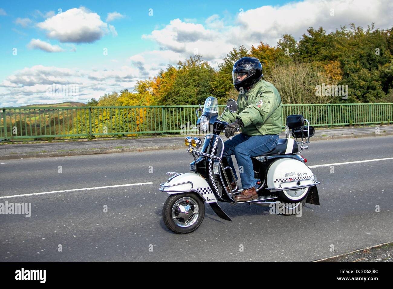 white Vespa Polini rider; two wheeled transport, scooter, vehicle, roads, motorbikes, bike riders motoring in Chorley, UK Stock Photo