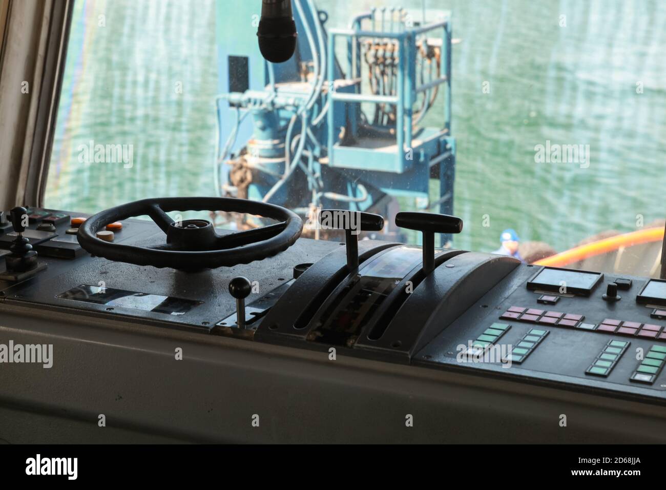 Control panel of an old tug boat. Captains bridge controls and steering wheel Stock Photo